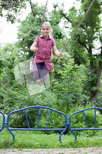 Image of Girl swinging with a big smile