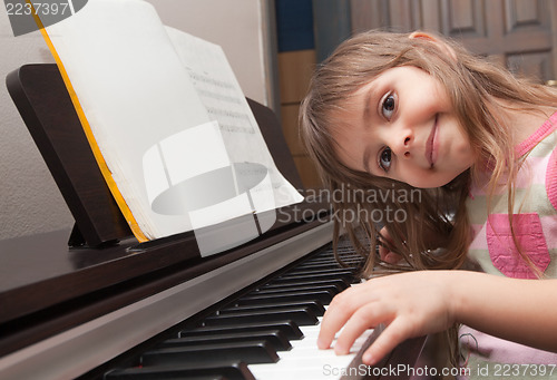 Image of Little girl playing piano