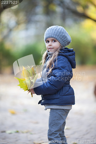 Image of Little girl holding the bouquet from leaves