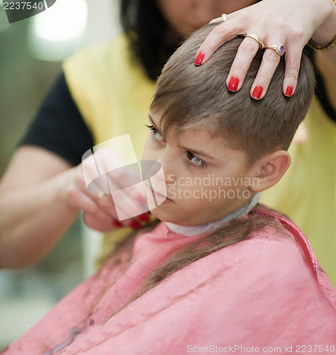 Image of Cute young boy getting haircut