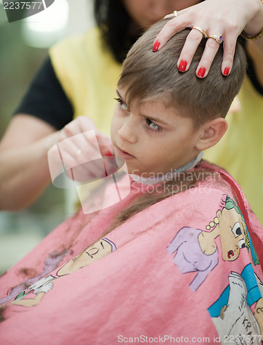 Image of Cute young boy getting haircut