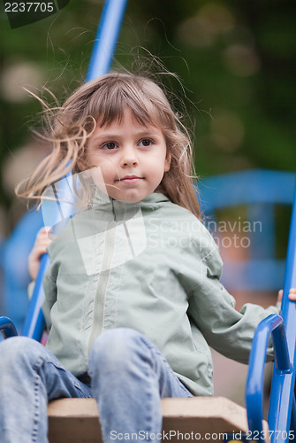 Image of Little girl on a swing