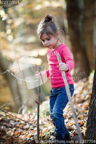 Image of Little girl hiking in the woods