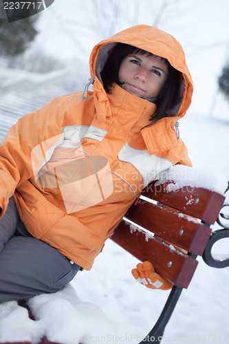 Image of Woman on snowy bench