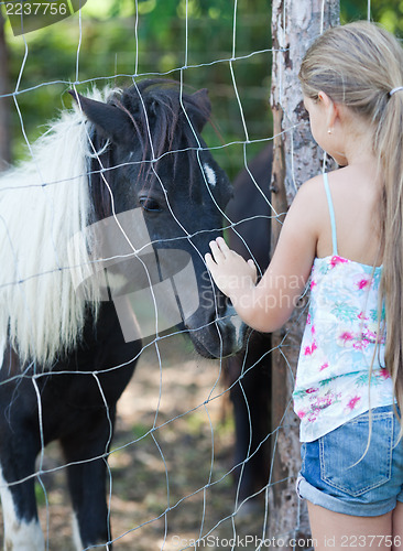 Image of Little girl and pony