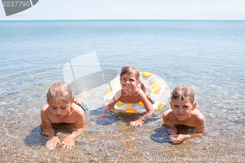 Image of Three children in the sea