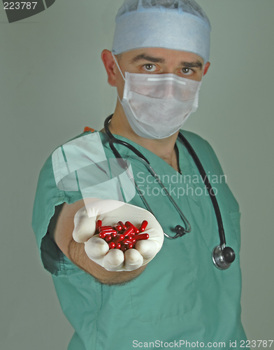 Image of Doctor giving the red capsules