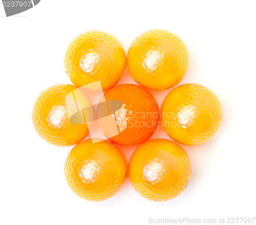 Image of Orange and golden golf balls