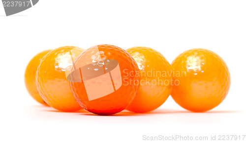 Image of Orange and golden golf balls