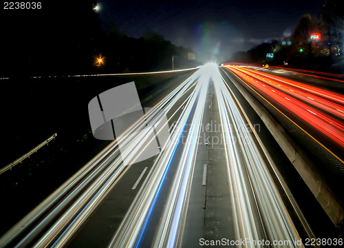 Image of standing in car on side of the road at night in the city