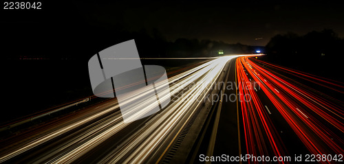 Image of standing in car on side of the road at night in the city