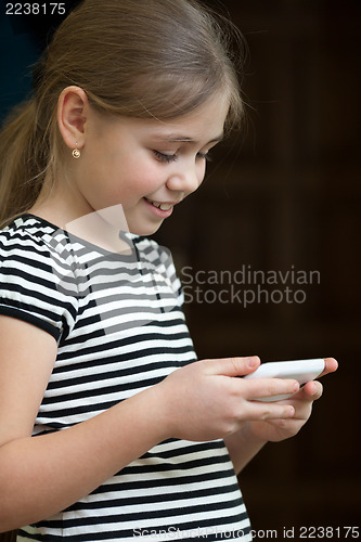 Image of Little girl reading sms on phone