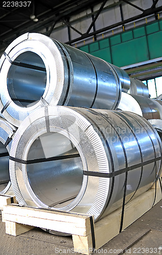 Image of rolls of steel sheet in a warehouse