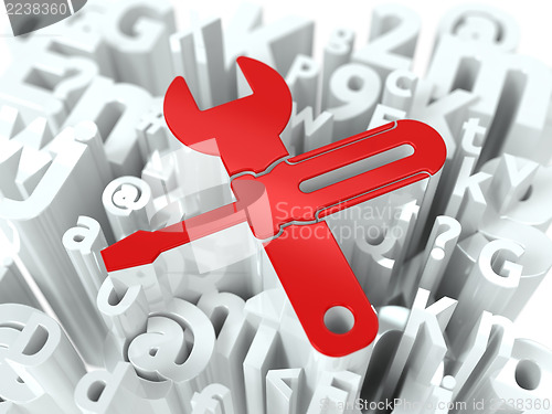 Image of Wrench and Screwdriver on Alphabet Background.