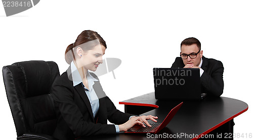 Image of Young Business Couple on Laptops