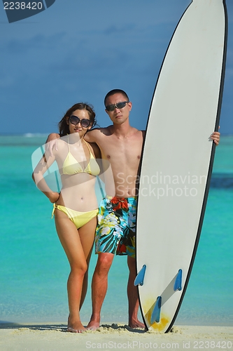 Image of happy young  couple enjoying summer on beach