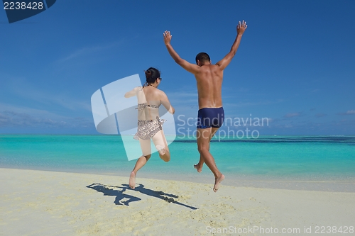 Image of happy young  couple enjoying summer on beach