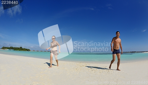 Image of happy young  couple enjoying summer on beach
