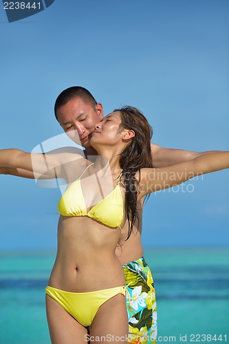 Image of happy young  couple enjoying summer on beach
