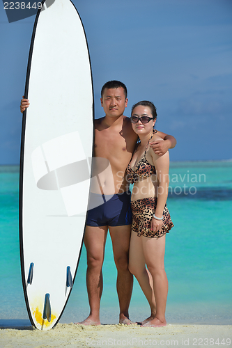 Image of happy young  couple enjoying summer on beach