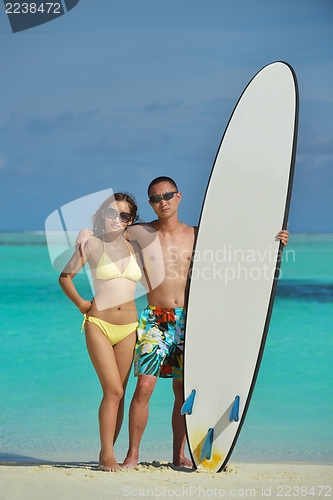 Image of happy young  couple enjoying summer on beach
