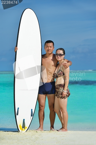 Image of happy young  couple enjoying summer on beach