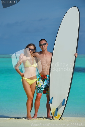 Image of happy young  couple enjoying summer on beach
