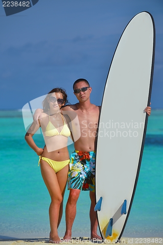 Image of happy young  couple enjoying summer on beach