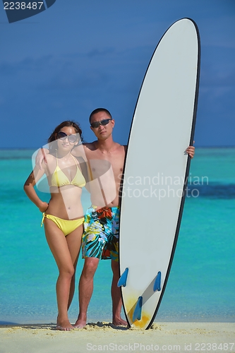 Image of happy young  couple enjoying summer on beach