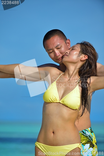 Image of happy young  couple enjoying summer on beach