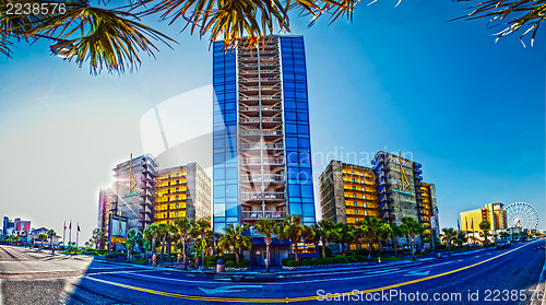 Image of beach scene,  blue sky and hotel