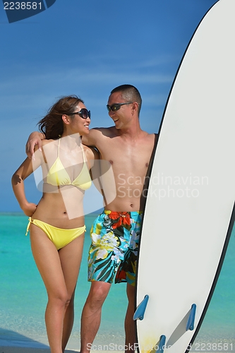 Image of happy young  couple enjoying summer on beach