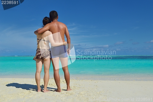 Image of happy young  couple enjoying summer on beach