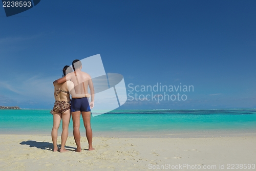 Image of happy young  couple enjoying summer on beach