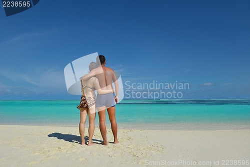 Image of happy young  couple enjoying summer on beach