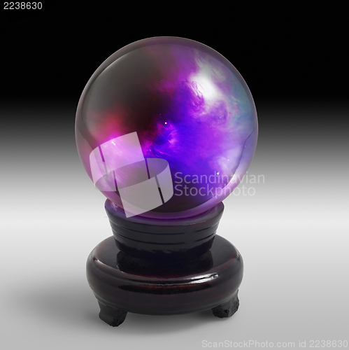 Image of crystal ball on stand in light back