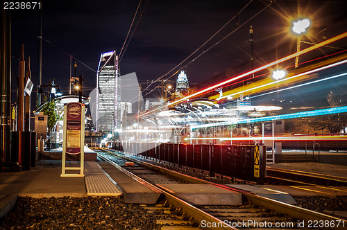 Image of Charlotte City Skyline night scene with light rail system lynx t