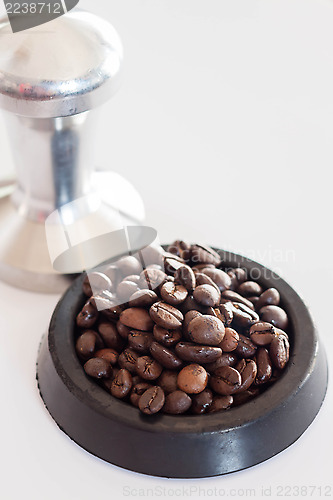 Image of Middle roasted coffee bean in rubber saucer