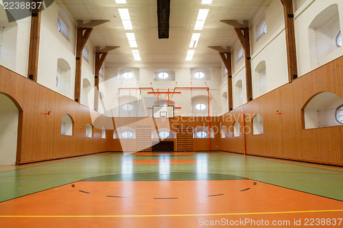 Image of Empty interior of public gym with basketball court