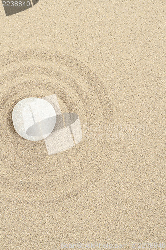 Image of zen stone in sand with circles