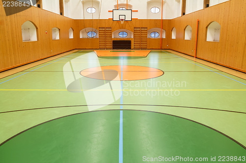 Image of Empty interior of public gym with basketball court