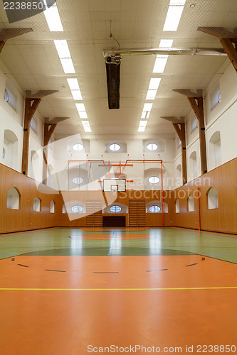 Image of Empty interior of public gym with basketball court