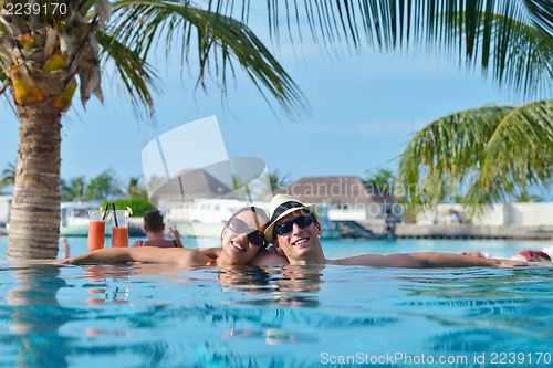 Image of happy young couple have fun on beach