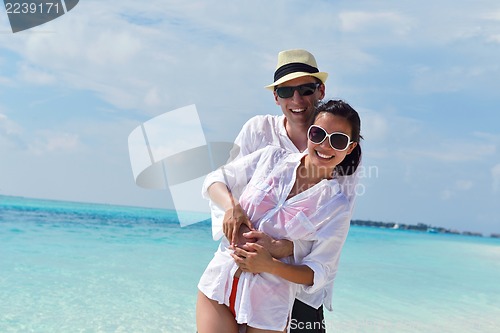 Image of happy young couple have fun on beach