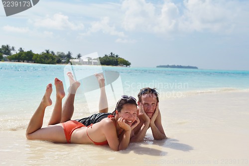 Image of happy young couple have fun on beach