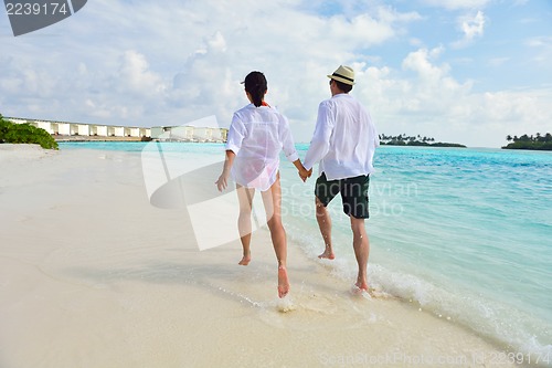 Image of happy young couple have fun on beach