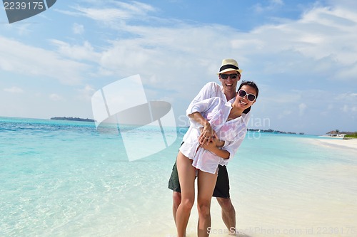 Image of happy young couple have fun on beach
