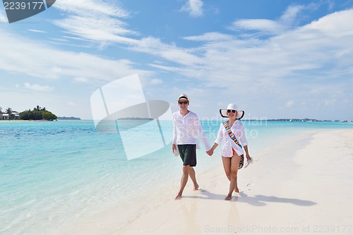 Image of happy young couple have fun on beach