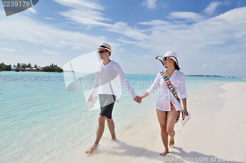 Image of happy young couple have fun on beach