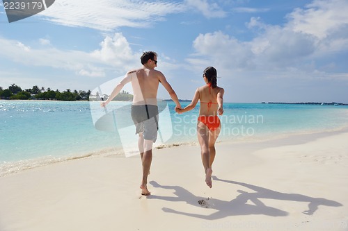 Image of happy young couple have fun on beach